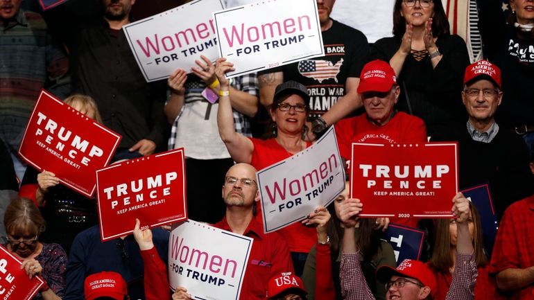 Supporters cheer as President Donald Trump speaks at a campaign...