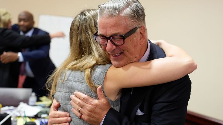 Actor Alec Baldwin hugs a member of his legal team...