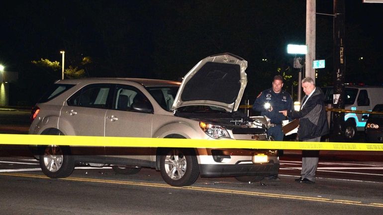 Suffolk County police investigate a motor-vehicle crash that killed John...