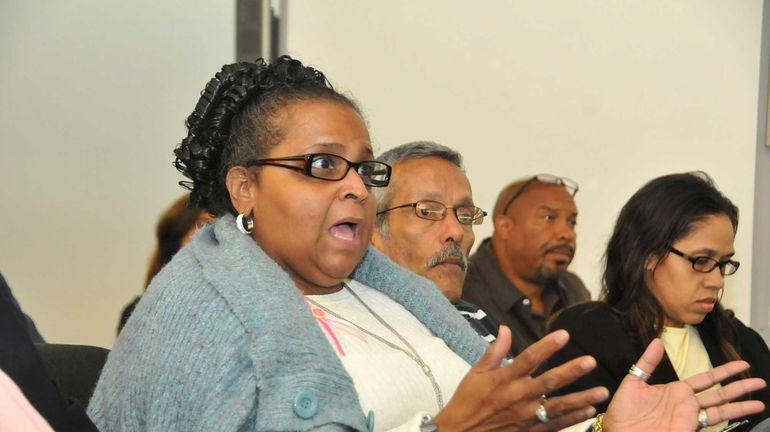 Amparo Sadler, of Central Islip, addresses the school board with...