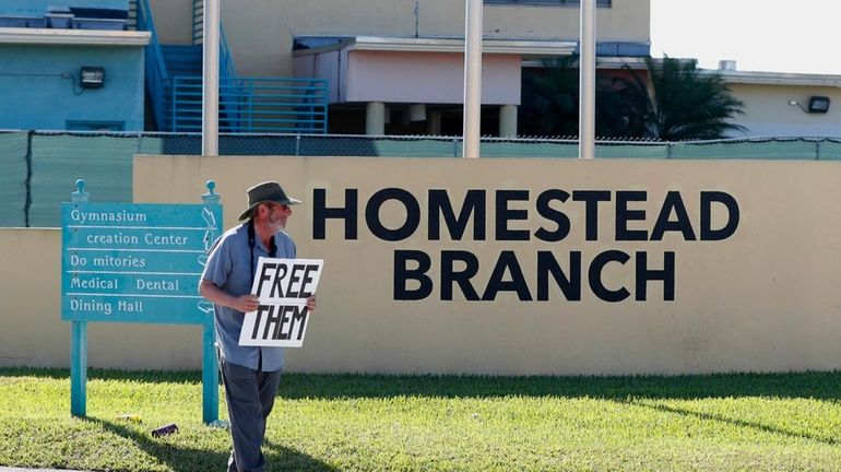 Josh Rubin demonstrates in front of the Homestead Temporary Shelter...