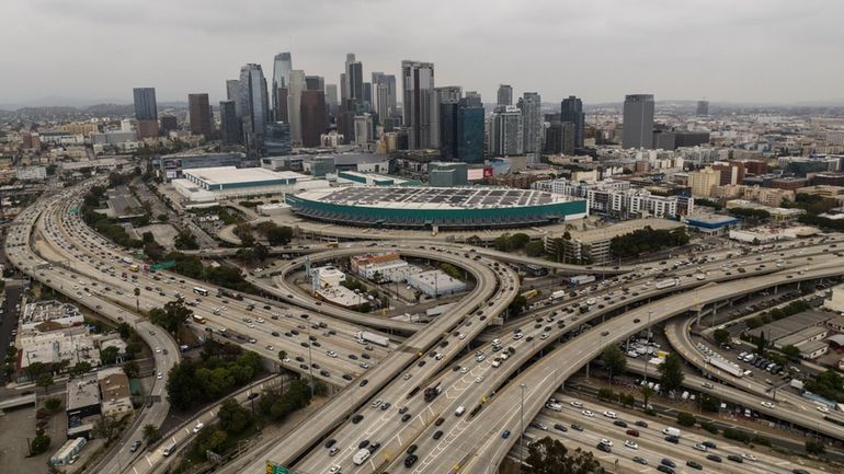 This aerial view shows a view of downtown Los Angeles,...