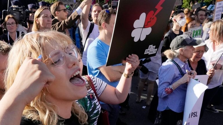 A woman chants before Poland's parliament during a protest against...