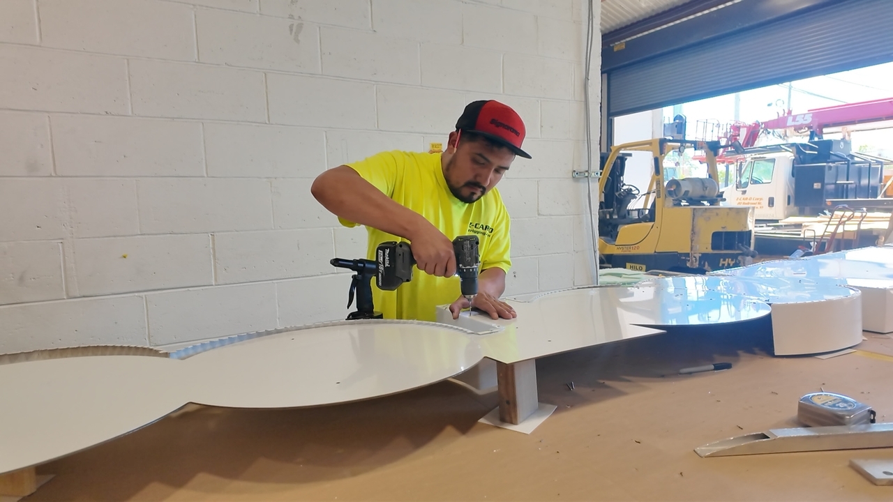 LI Works: Ken lights up the room as he makes signs