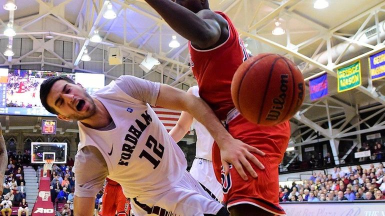 Fordham guard Joseph Chartouny is fouled by St. John's forward...