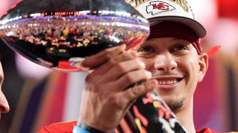 Kansas City quarterback Patrick Mahomes holds the Vince Lombardi Trophy...