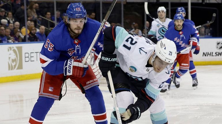 Ryan Lindgren of the Rangers defends against Alex Wennberg of the...