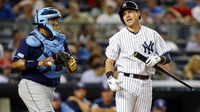 Jacoby Ellsbury of the Yankees reacts after striking out in...