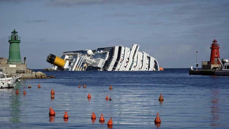 Cruise liner Costa Concordia lying aground in front of the...