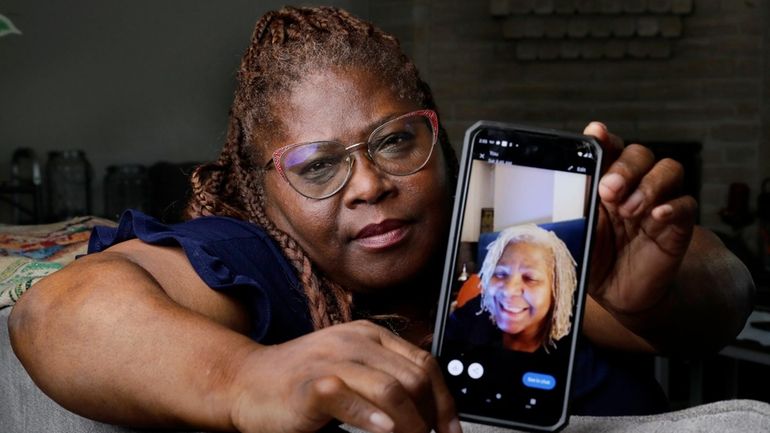 Janet Jarrett shows a photo of her sister, Pamela Jarrett,...