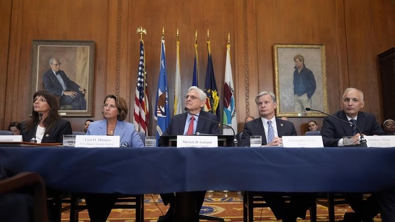 Attorney General Merrick Garland, center, speaks before a meeting of...