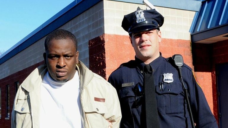 Evans Ganthier, 30, of Central Islip, is led out of...