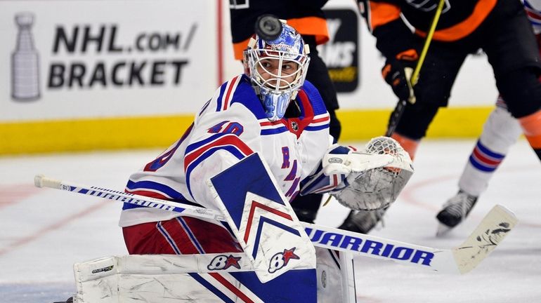 Rangers goaltender Alexandar Georgiev looks for the puck after making...