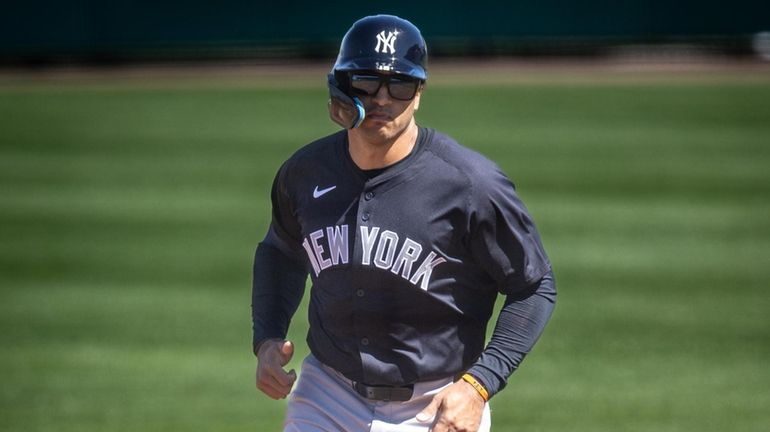 Yankees’ Trent Grisham round the bases after hitting a three...