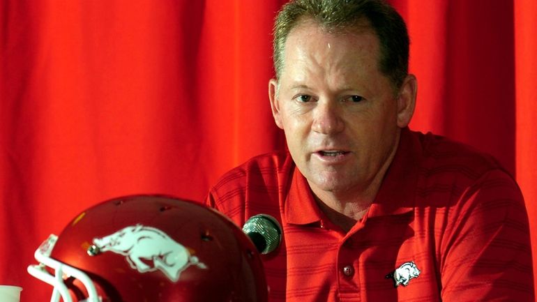 Arkansas football coach Bobby Petrino answers a question during media...