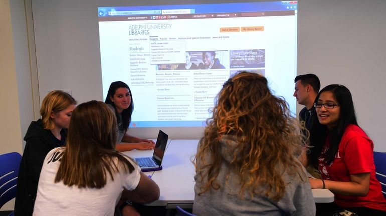 Adelphi students work in the new digitized classroom at the...