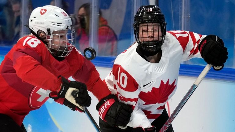 Switzerland's Stefanie Wetli, left, and Canada's Sarah Fillier battle for the...