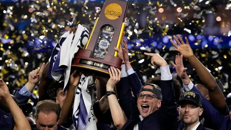 Connecticut head coach Dan Hurley celebrates with the trophy after...