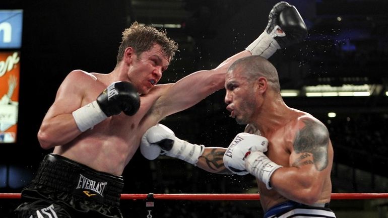 (L-R) Yuri Foreman exchanges blows with Miguel Cotto of Puerto...