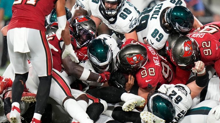 Philadelphia Eagles' Jalen Hurts, center, scores a touchdown during the...