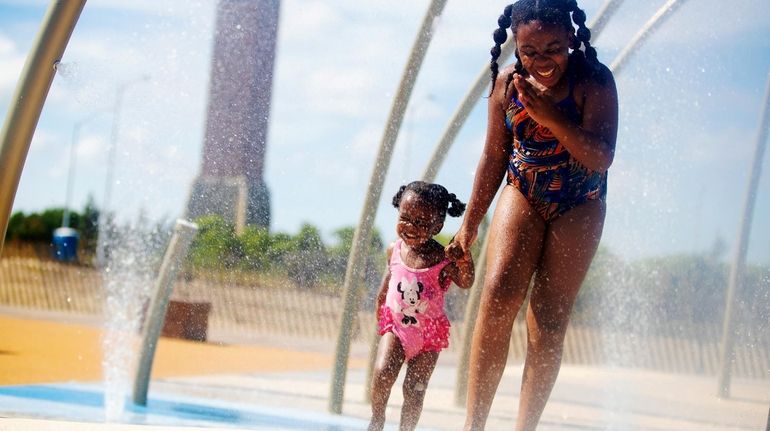 Sisters Saija and Sheyanne Sinclair of Merrick enjoy the new splash...