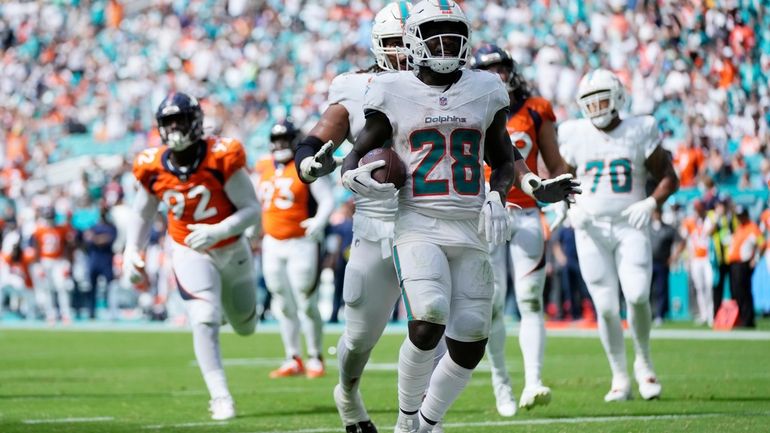 Miami Dolphins running back De'Von Achane (28) celebrates after scoring...