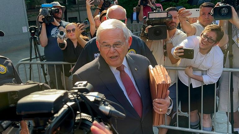 United States Sen. Bob Menendez, D-N.J.,, center, leaves federal court...