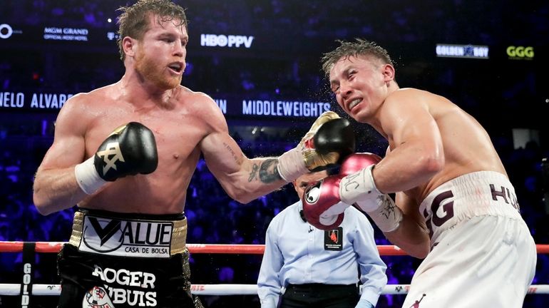 FILE - Canelo Álvarez lands a punch against Gennadiy Golovkin...