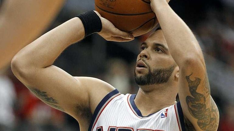 New Jersey Nets point guard Deron Williams scores a free...