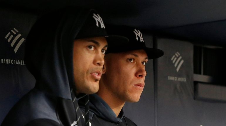 Giancarlo Stanton and Aaron Judge of the Yankees looks on from...