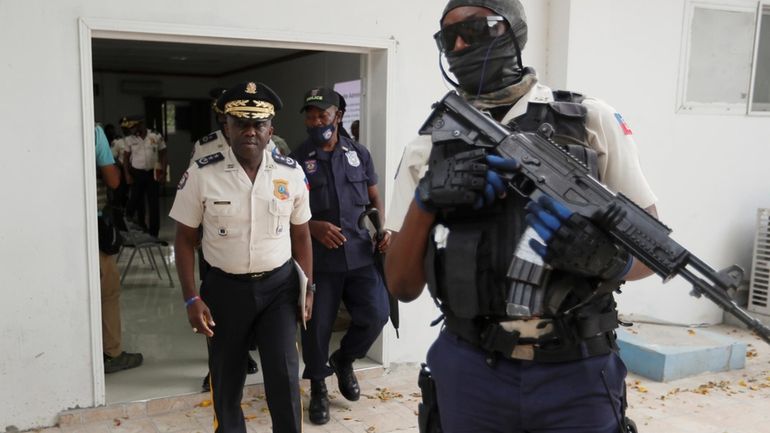 Leon Charles, left, Director General of Haiti's Police leaves a...