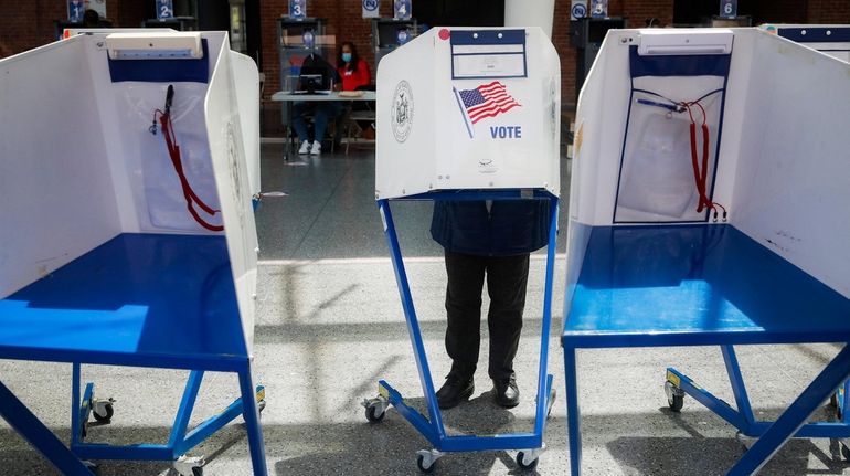 A voter fills out their ballot at a polling station...