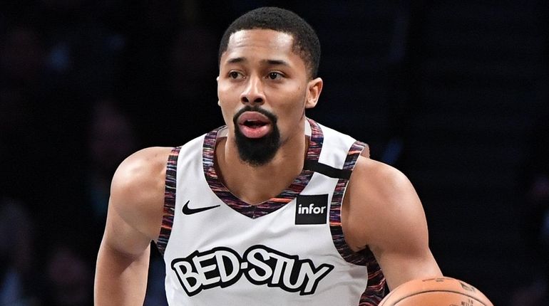 Nets guard Spencer Dinwiddie dribbles the ball up court against...