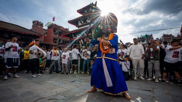 A masked dancer performs during Indra Jatra, a festival that...