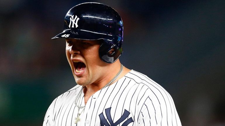 Luke Voit celebrates after hitting a two-run single in the...