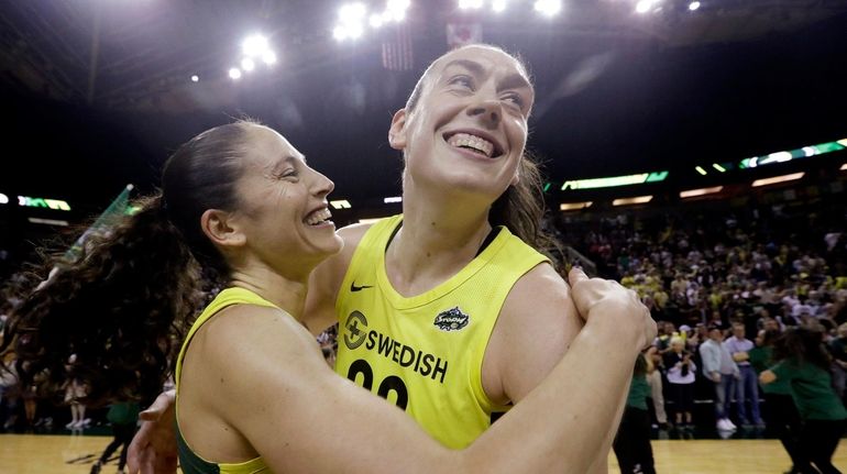 Seattle Storm's Breanna Stewart, right, is embraced by Sue Bird...