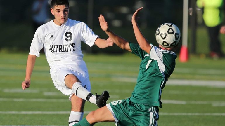 East Setauket Ward's Melville's Anthony Passiatore #9 clears the ball...