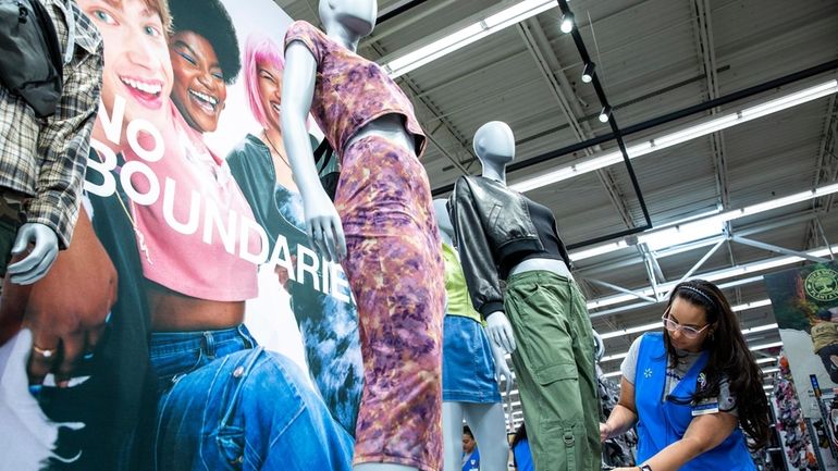 A Walmart's staff member works on a display of the...