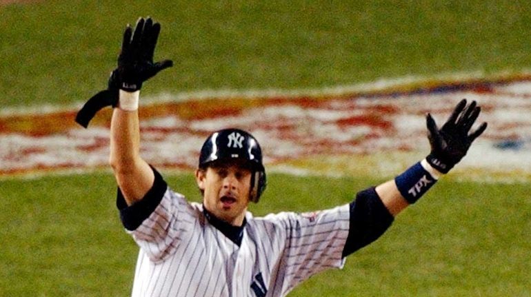 Yankees' Aaron Boone celebrates his game-winning home run off Red...