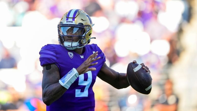 Washington quarterback Michael Penix Jr. looks to throw against Tulsa...