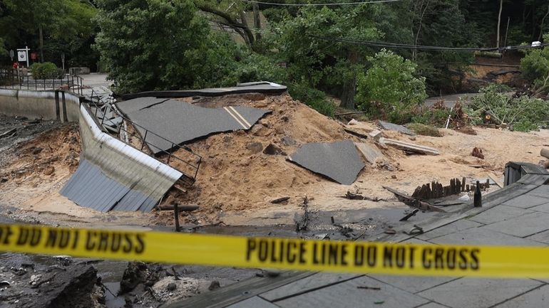 Damage seen on Tuesday after flooding rains caused the Mill Pond...