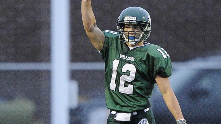 Lindenhurst Bulldogs' Peter Mangione reacts after he returns the opening...