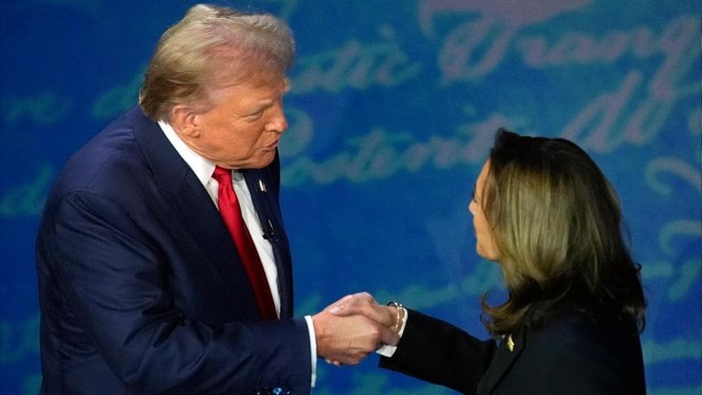 Republican presidential nominee former President Donald Trump shakes hands with...