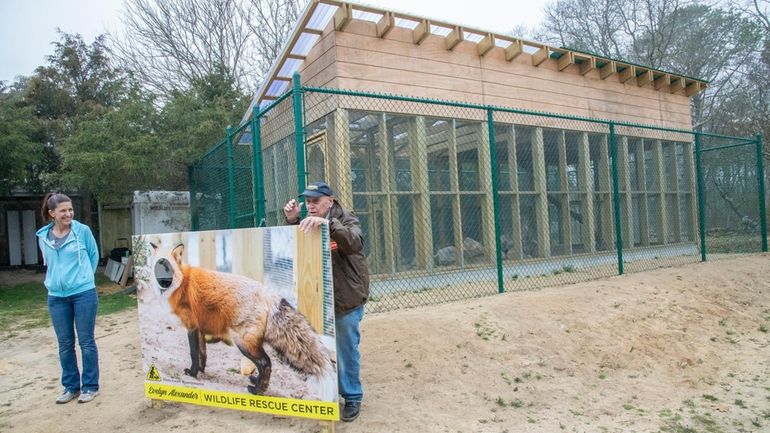 Tammy Flanell, left, a rescue center staff member, and John...