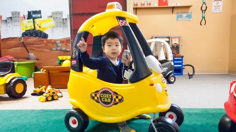 Cornelius Chung, of Hicksville, uses the radio in his cab...