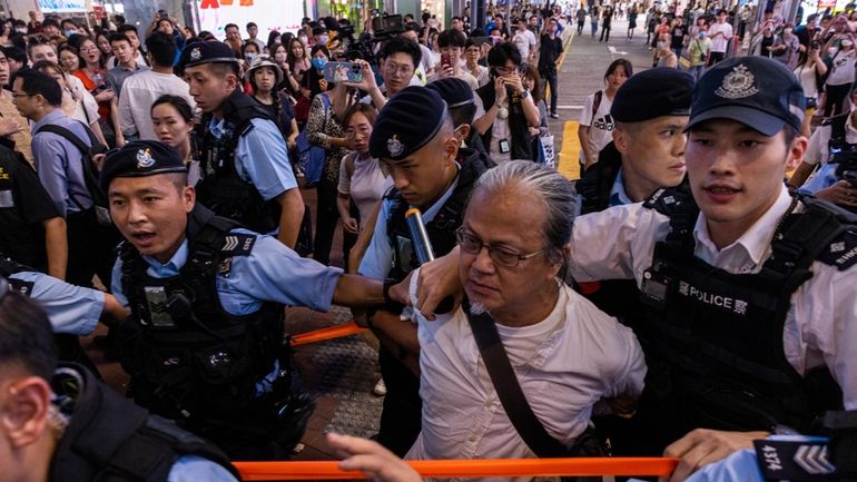 A member of the public is taken away by the...