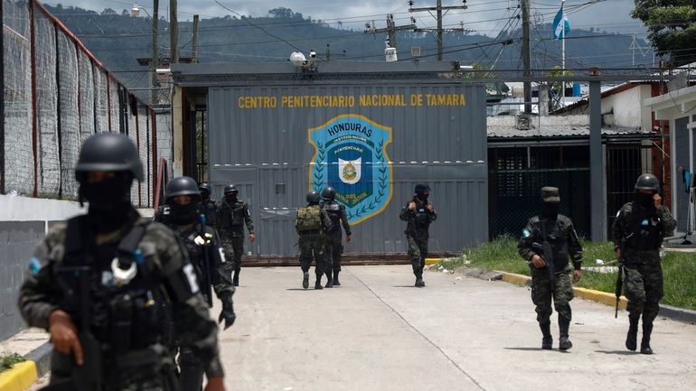 Military police guard the entrance to the National Penitentiary Center...