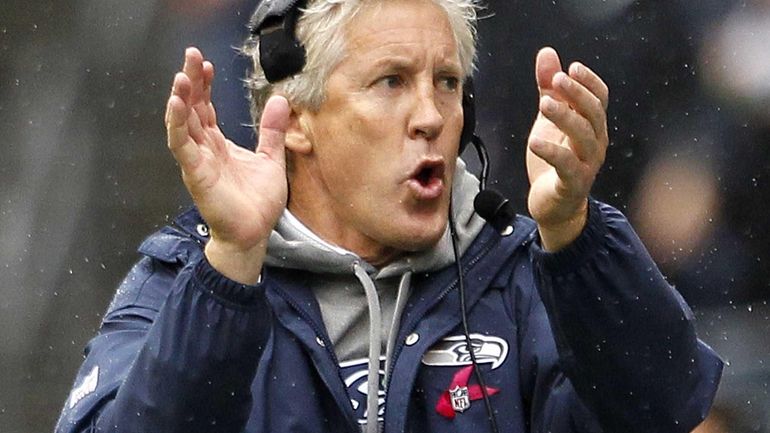 Seattle Seahawks head coach Pete Carroll applauds from the sidelines...