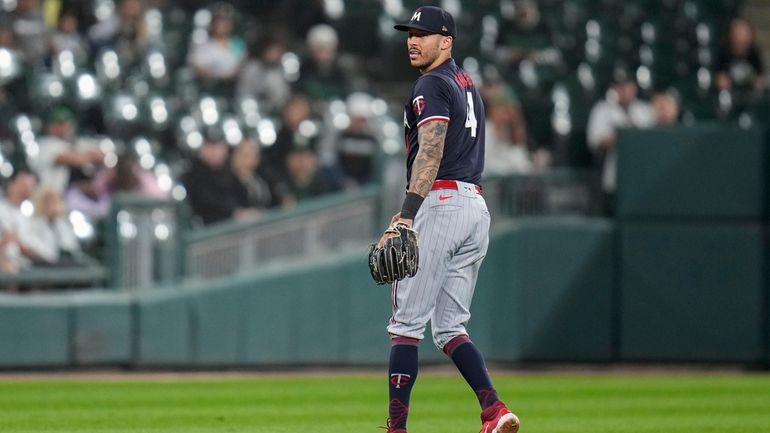 Minnesota Twins shortstop Carlos Correa drops a ground ball from...