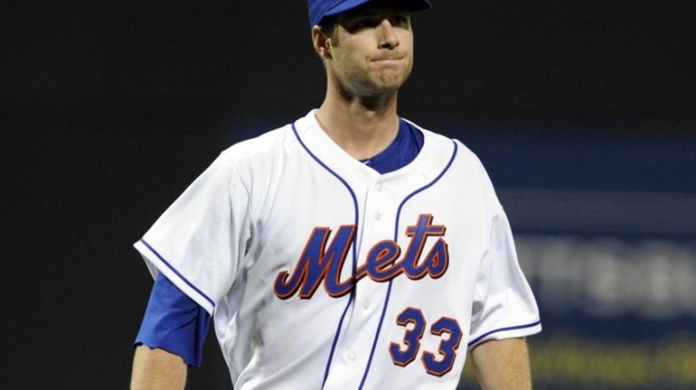 John Maine of the New York Mets grimaces as he...